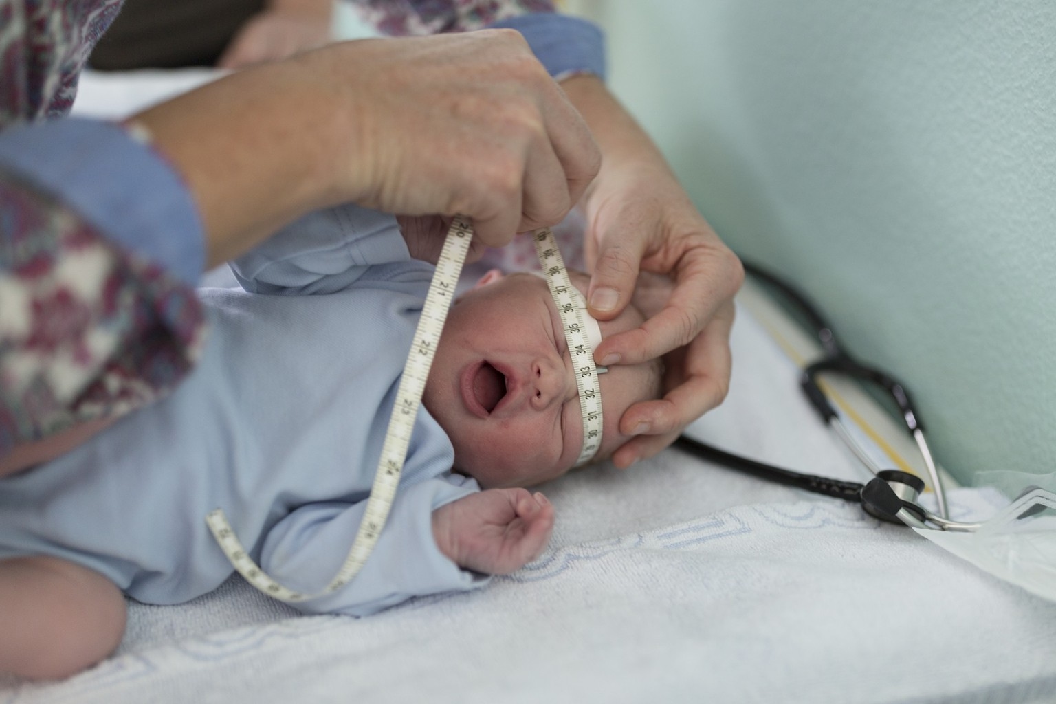 A midwife measures the head circumference of a newborn infant named Julia at the maternity unit of the Triemli Hospital in Zurich, Switzerland, on September 27, 2016. Julia was delivered by cesarean s ...