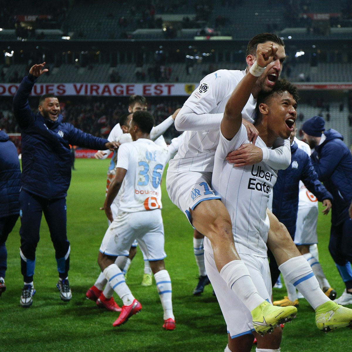 Marseille's players celebrate their victory after the French League One soccer match between Lille and Marseille at the Lille Metropole stadium in Villeneuve d'Ascq, northern France, Sunday, ...