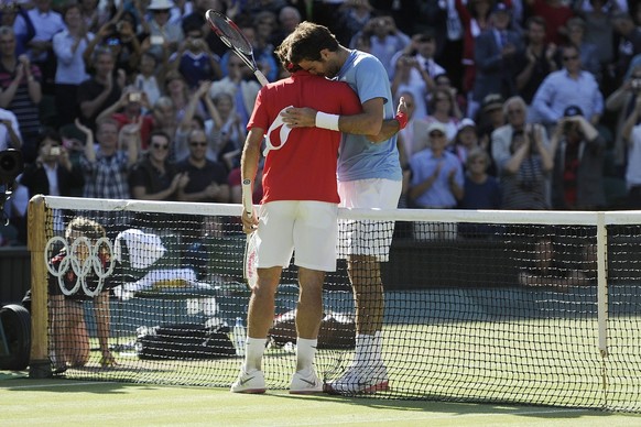 Switzerland&#039;s Roger Federer, left, and Argentina&#039;s Juan Martin Del Potro, right, reacts during the men&#039;s semifinal singles match against Argentina&#039;s Juan Martin Del Potro at Wimble ...