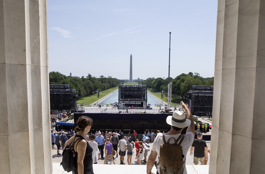 epa07692654 Visitors look at the temporary decorations and bleachers at the Lincoln Memorial as preparations continue for the US Independence Day celebrations on the National Mall in Washington, DC, U ...