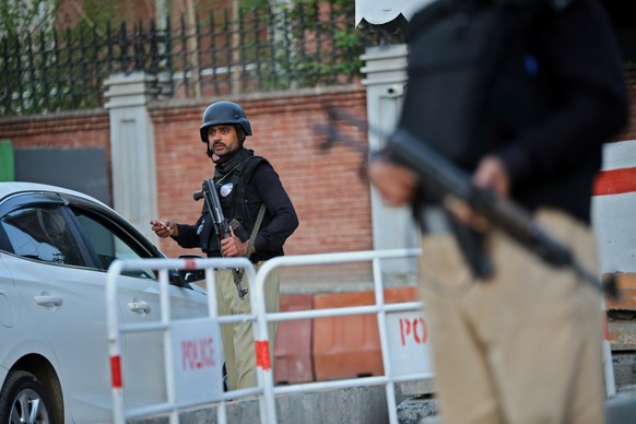 epa10520810 Pakistani security officials stand guard at a check point in Peshawar, the provincial capital of KPK province, Pakistan, 13 March 2023. The Counter Terrorism Department (CTD) has last week ...