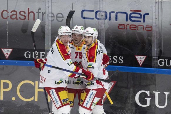 From left, Biel&#039;s players Jere Sallinen, Alexander Yakovenko and Robin Grossmann, celebrate the 0-1 goal, during the preliminary round game of the National League 2022/23 between, HC Lugano again ...