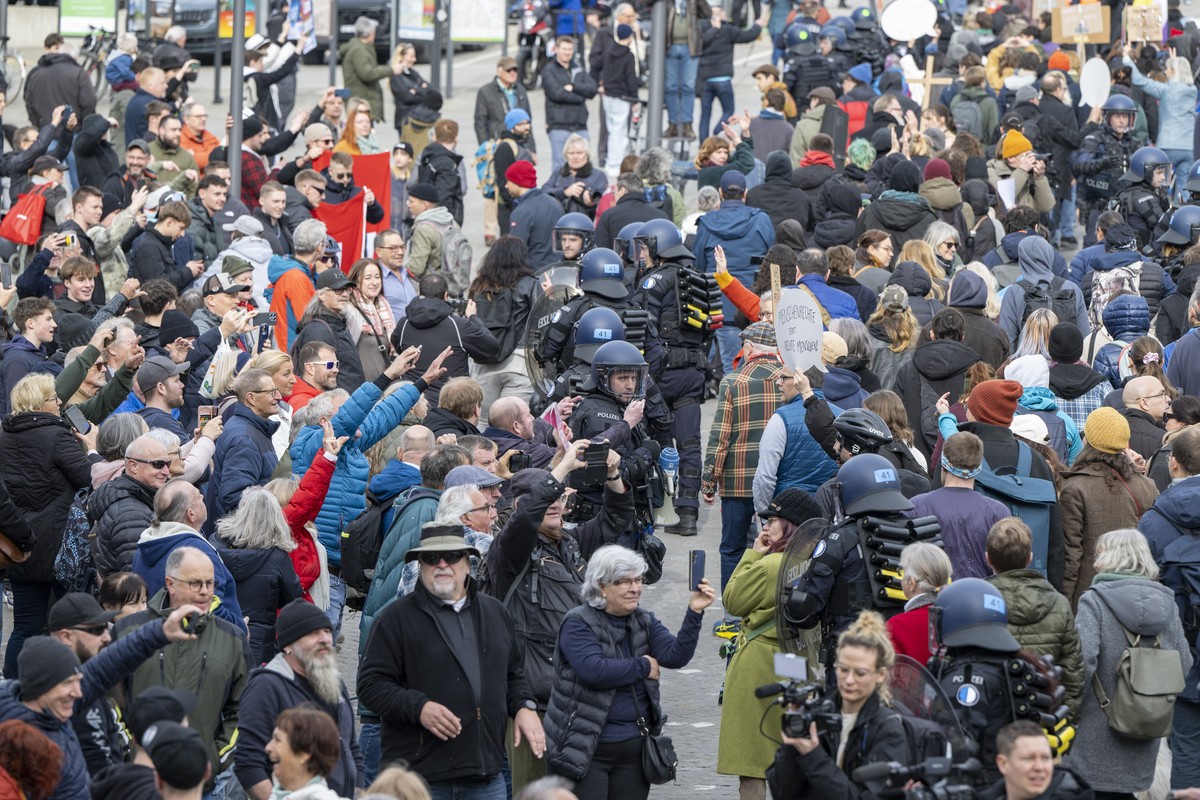 epa11915511 People take part in the 'Demo against the right' rally in solidarity with Germany as others are against it, in Einsiedeln, Switzerland, 22 February 2025. An authorized 'Demo ...