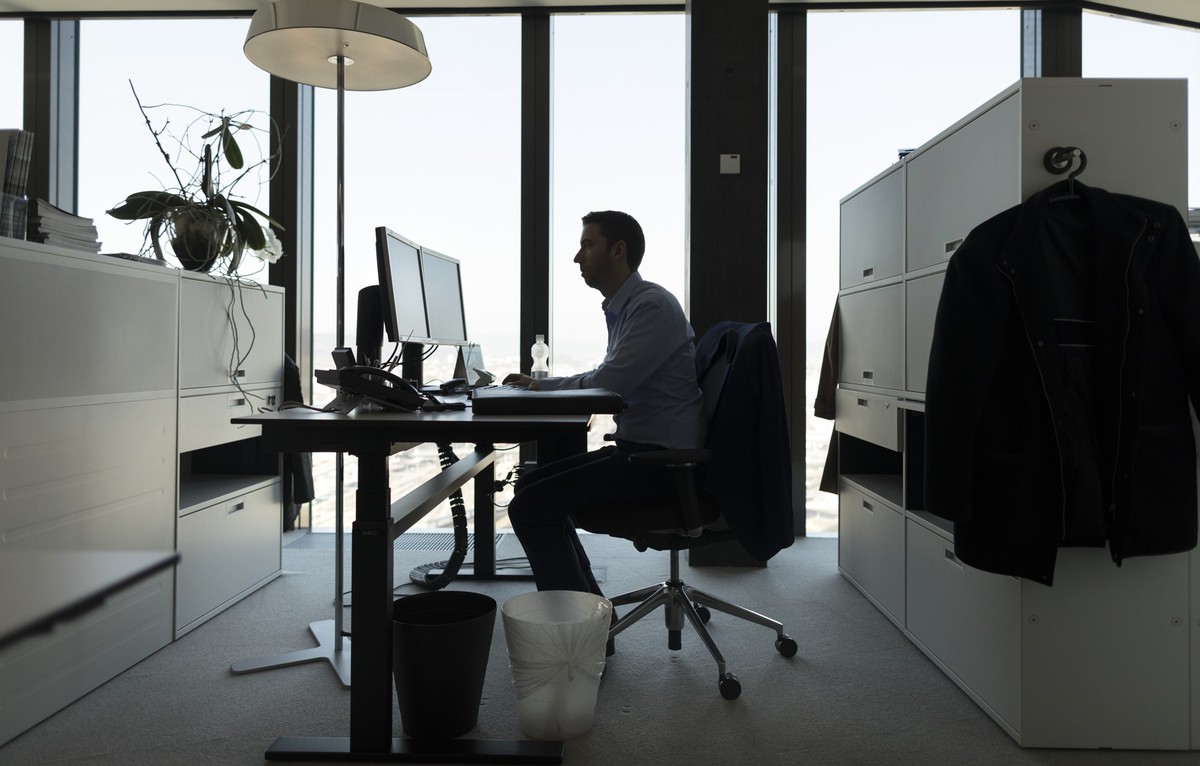 A GAM employee works at his desk in an office at the Prime Tower, a skyscraper, where the pure play asset management group GAM is headquartered, pictured in Zurich, Switzerland, on March 13, 2017. (KE ...