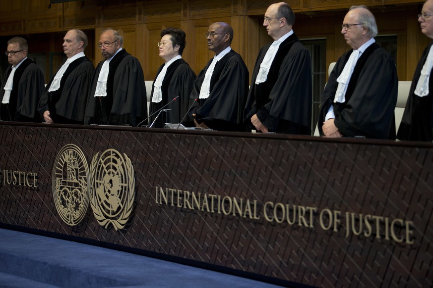 Judges enter the International Court of Justice, or World Court, in The Hague, Netherlands, Wednesday, Oct. 3, 2018, where they ruled on an Iranian request to order Washington to suspend U.S. sanction ...