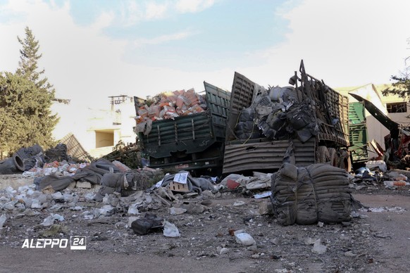 This image provided by the Syrian anti-government group Aleppo 24 news, shows damaged trucks carrying aid, in Aleppo, Syria, Tuesday, Sept. 20, 2016. A U.N. humanitarian aid convoy in Syria was hit by ...