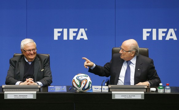 FIFA President Sepp Blatter (R) talks to Theo Zwanziger, former president of the German Football Association (DFB) and member of the FIFA&#039;s executive committee as they address a news conference i ...