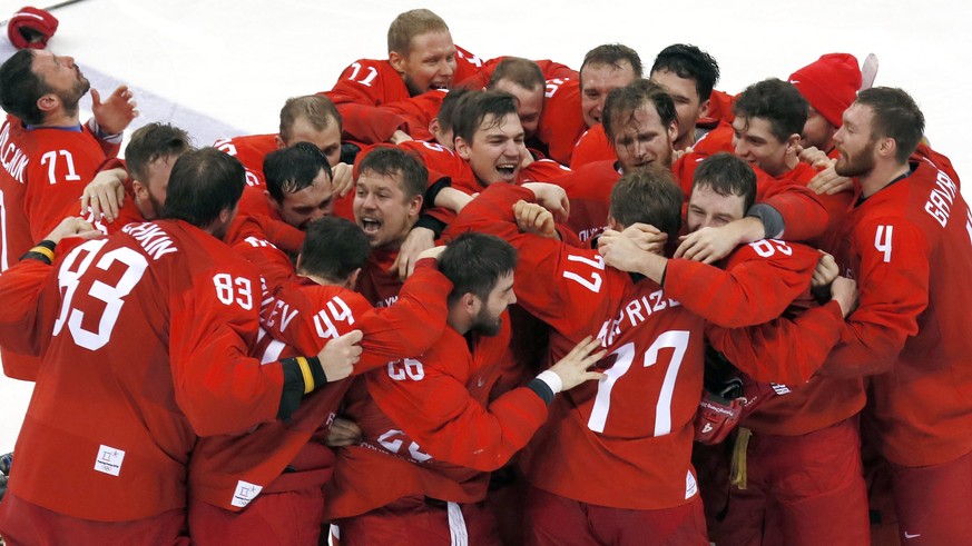 epaselect Kirill Kaprizov of Olympic Athletes of Russia (OAR) (C, number 77) s surrounded by his teammates after scoring the winning goal as the team and coaches (background) jubilate their win in the ...