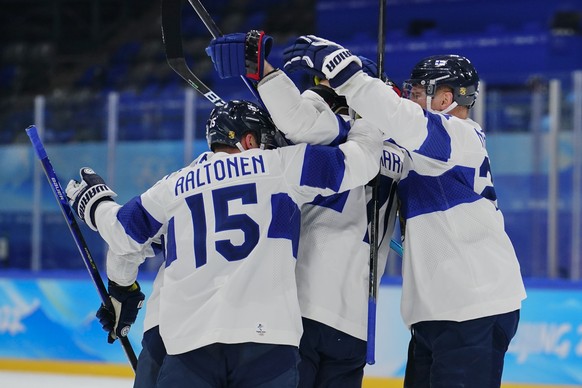 Finland players celebrate after Leo Komarov (71) scored a goal against Latvia during a preliminary round men&#039;s hockey game at the 2022 Winter Olympics, Friday, Feb. 11, 2022, in Beijing. (AP Phot ...