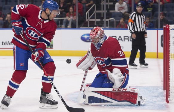 RETRANSMISSION TO CORRECT CITY TO QUEBEC CITY - Montreal Canadiens goalie Carey Price, right, makes a save as teammate Mark Streit skates to the net against the Toronto Maple Leafs during the first pe ...