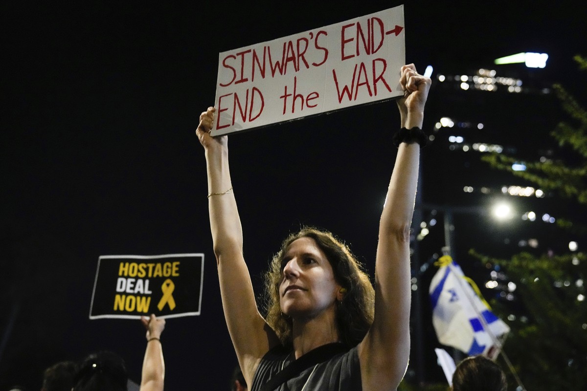 A demonstrator holds a sign about the killing of Hamas leader Yahya Sinwar during a protest calling for a cease-fire deal and the immediate release of hostages held by Hamas on Thursday, Oct. 17, 2024 ...