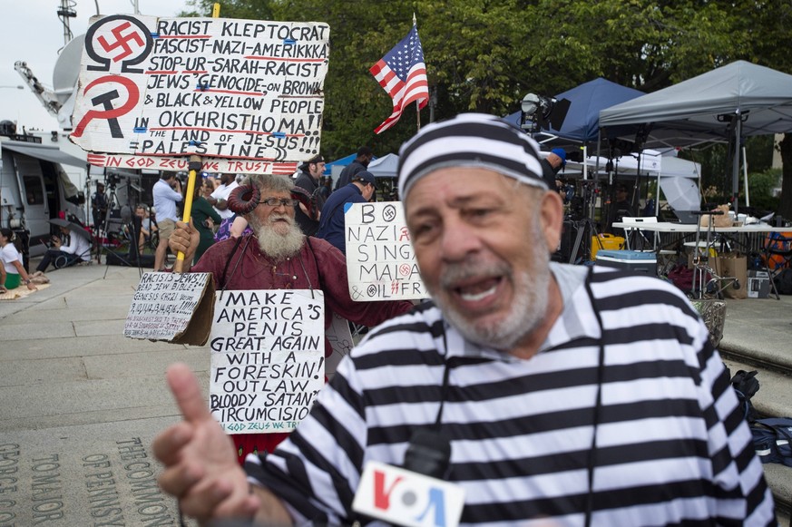 People on sides of the issue gather outside the E. Barrett Prettyman United States Courthouse prior to the arrival of former US President Donald J. Trump for his arraignment in Washington, DC, Thursda ...