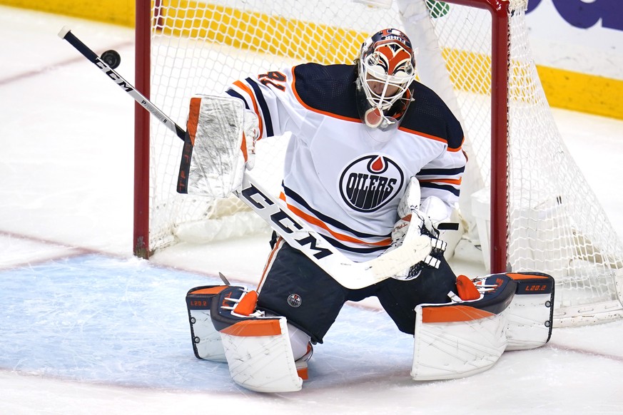 Edmonton Oilers goaltender Mike Smith blocks a Pittsburgh Penguins shot during the first period of an NHL hockey game in Pittsburgh, Tuesday, April 26, 2022. (AP Photo/Gene J. Puskar)
