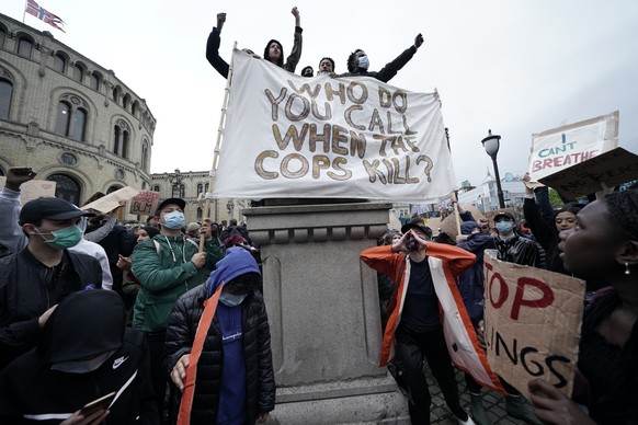 Protesters gather at a demonstration outside the Parliament building in Oslo, Friday, June 5, 2020, over the death of George Floyd, a black man who died after being restrained by Minneapolis police of ...