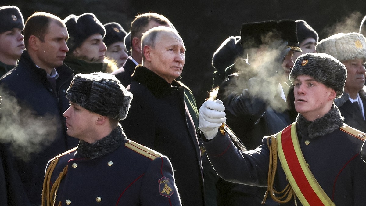 FILE - Russian President Vladimir Putin, center left, attends a wreath-laying ceremony at the Tomb of the Unknown Soldier, near the Kremlin Wall during the national celebrations of the "Defender  ...