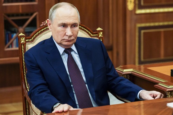 Russian President Vladimir Putin, listens to Chief Justice of Russia Igor Krasnov, not pictured, during their meeting at the Kremlin in Moscow, Wednesday, Nov. 5, 2025. (Gavriil Grigorov, Sputnik, Kre ...