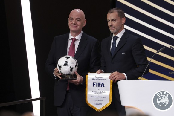 epa12730368 FIFA President Gianni Infantino (L) and UEFA President Aleksander Ceferin (R) attend the 50th UEFA Ordinary Congress in Brussels, Belgium, 12 February 2026. EPA/CHRISTOPHER NEUNDORF