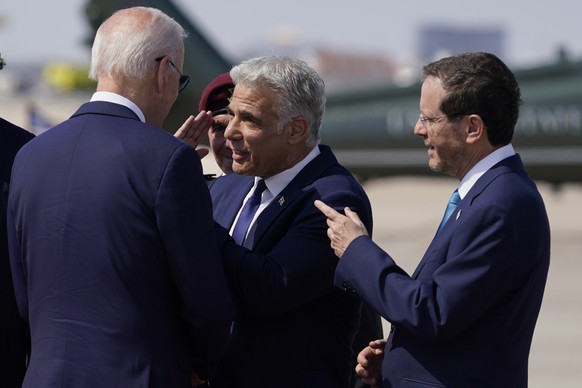 U.S. President Joe Biden shakes hands with Israel&#039;s Prime Minister Yair Lapid before his departure to Saudi Arabia from Ben Gurion airport near Tel Aviv, Israel Friday, July 15, 2022. On the righ ...