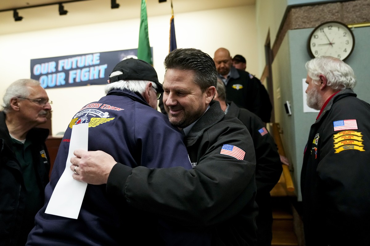 IAM District 751 president Jon Holden greets union members after announcing they voted to accept a new contract offer from Boeing, Monday, Nov. 4, 2024, at their union hall in Seattle. (AP Photo/Linds ...