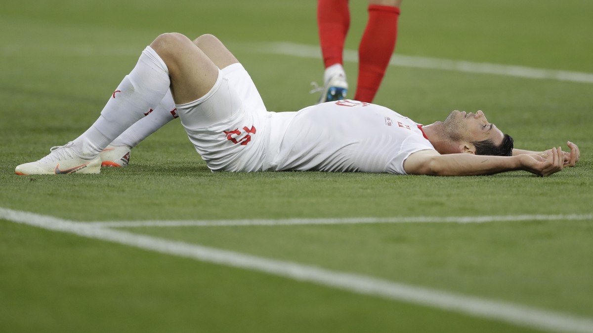 Switzerland's Blerim Dzemaili lies on the ground during the group E match between Switzerland and Serbia at the 2018 soccer World Cup in the Kaliningrad Stadium in Kaliningrad, Russia, Friday, Ju ...