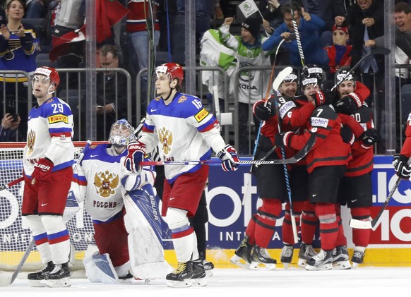 Canada&#039;s players celebrate a goal by Canada&#039;s Ryan O&#039;Reilly, right, at the Ice Hockey World Championships semifinal match between Canada and Russia in the LANXESS arena in Cologne, Germ ...