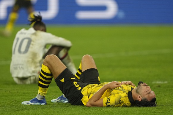 Dortmund&#039;s Ramy Bensebaini, right, and AC Milan&#039;s Rafael Leao gesture at the end of the Champions League Group F soccer match between Borussia Dortmund and AC Milan at the Signal Iduna Park  ...