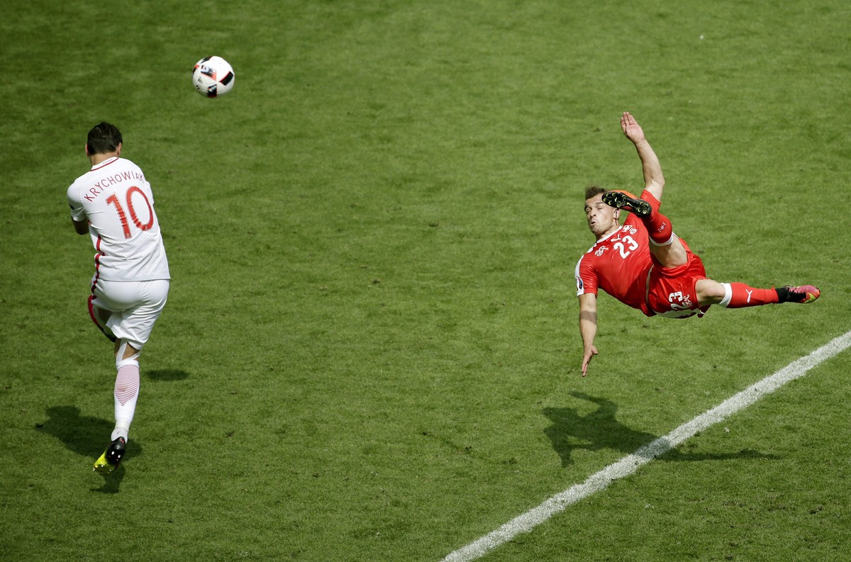 epa05601735 YEARENDER 2016 JUNE
Xherdan Shaqiri of Switzerland (R) scores a goal as Grzegorz Krychowiak of poland tries to defend, during their UEFA EURO 2016 round of 16 match at the Stade Geoffroy  ...