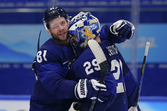 Finland&#039;s Iiro Pakarinen (81) hugs goalkeeper Harri Sateri (29) after Finland defeated Slovakia in a men&#039;s semifinal hockey game at the 2022 Winter Olympics, Friday, Feb. 18, 2022, in Beijin ...