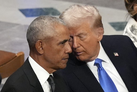Former President Barack Obama talks with President-elect Donald Trump before the state funeral for former President Jimmy Carter at Washington National Cathedral in Washington, Thursday, Jan. 9, 2025. ...
