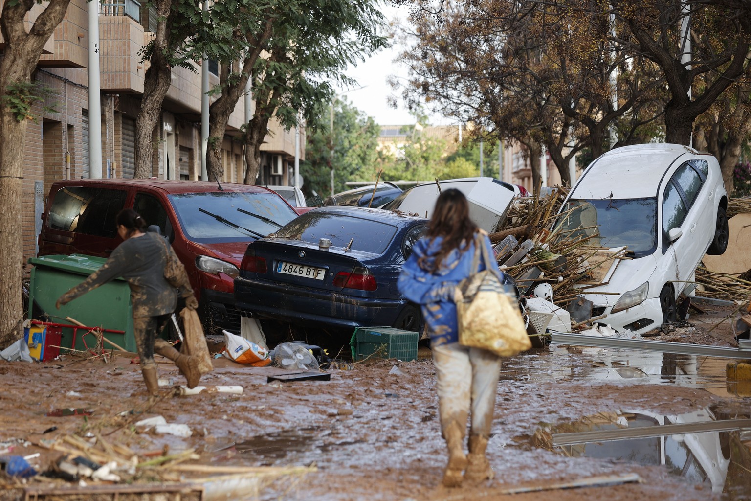 epa11693901 A resident walks through a damaged street resulting from flooding in the Municipality of Catarroja, Valencia, Spain, 31 October 2024. At least 95 people died in the province of Valencia an ...