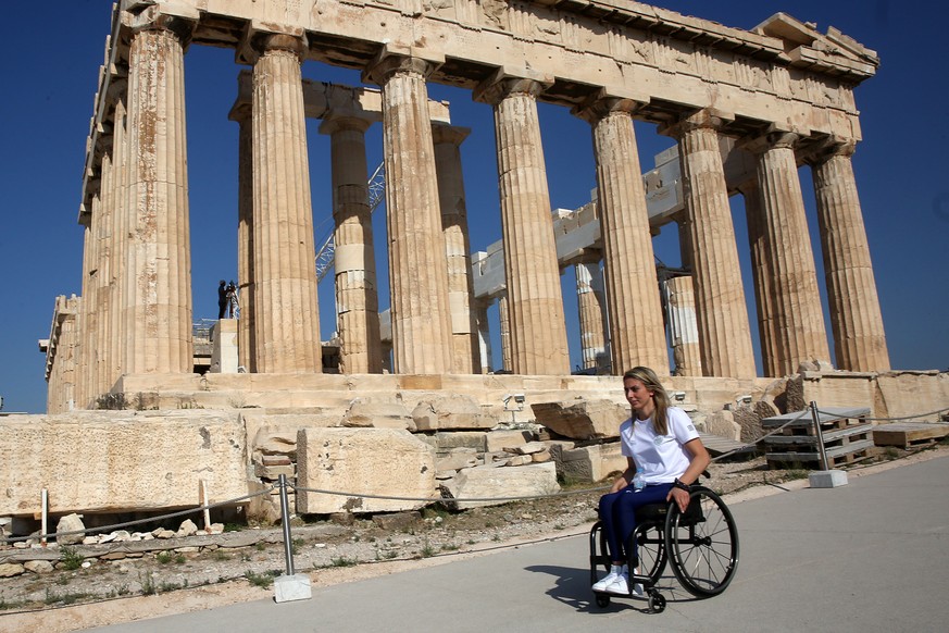 epa09354418 Kelly Loufaki, athlete of the Greek Paralympic team, visits the archaeological site of the Acropolis hill in Athens, a few days ahead of her departure to Tokyo, Athens, Greece, 20 July 202 ...