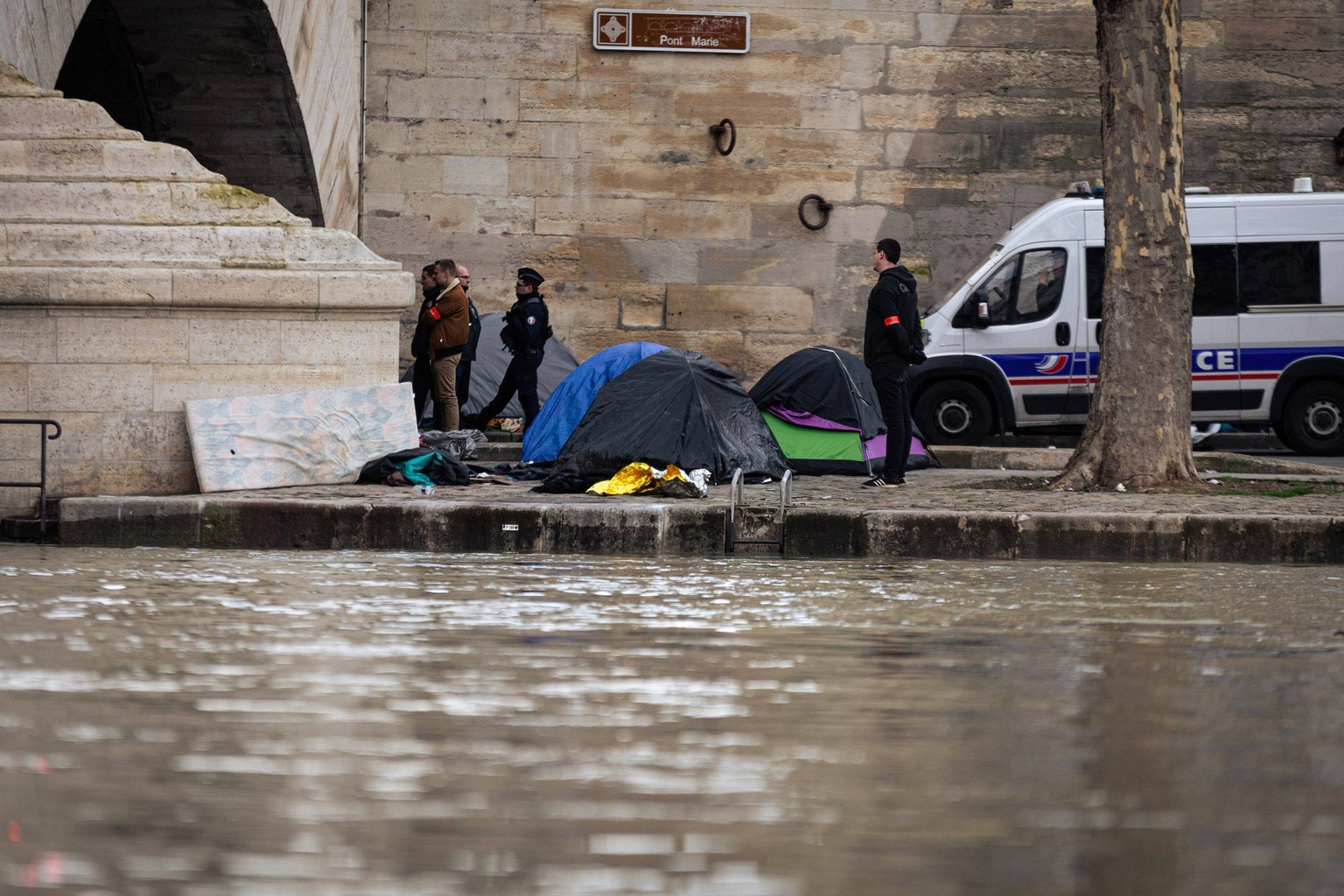 March 6, 2024, Paris, France: Police squad seen during the eviction of migrant minors camp under Pont Marie. A camp of migrant minors beneath Pont Marie on the banks of the River Seine was evicted by  ...