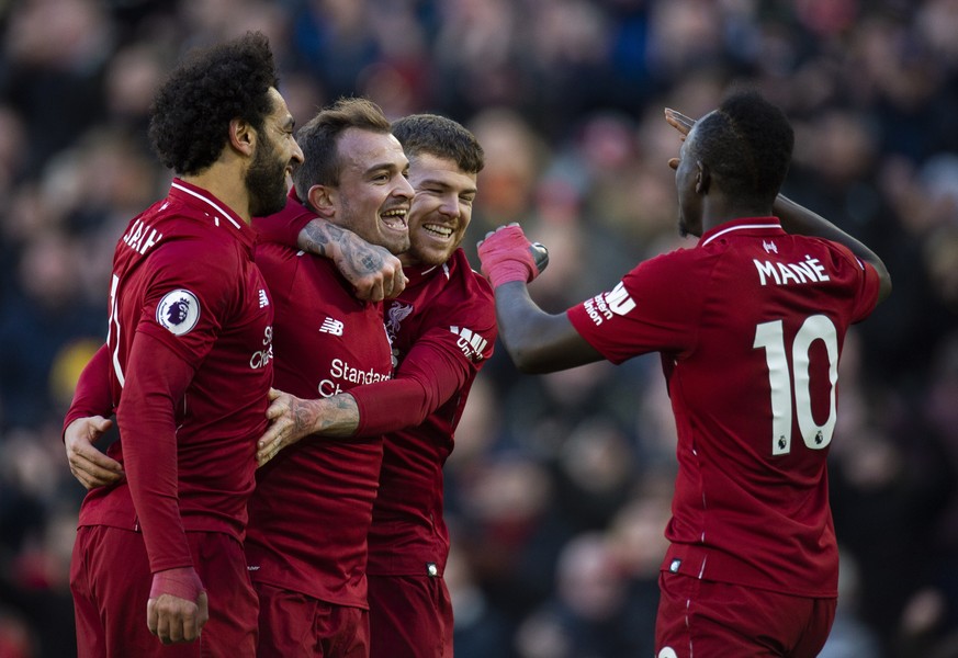 epa07124444 Liverpool&#039;s Xherdan Shaqiri is congratulated by his teammates after scoring the fourth goal during the English Premier League soccer match between Liverpool and Cardiff City at the An ...