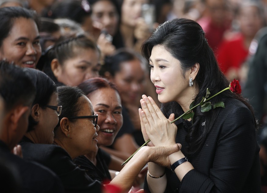 epa06229493 (FILE) - Former Thai Prime Minister Yingluck Shinawatra (R) performs the traditional Thai greeting as she arrives for her trial on criminal charges stemming from her government&#039;s rice ...