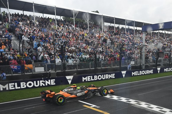 McLaren driver Lando Norris of Britain crosses the finish line to win the Australian Formula One Grand Prix at Albert Park, in Melbourne, Australia, Sunday, March 16, 2025. (Tracey Nearmy/Pool Photo v ...