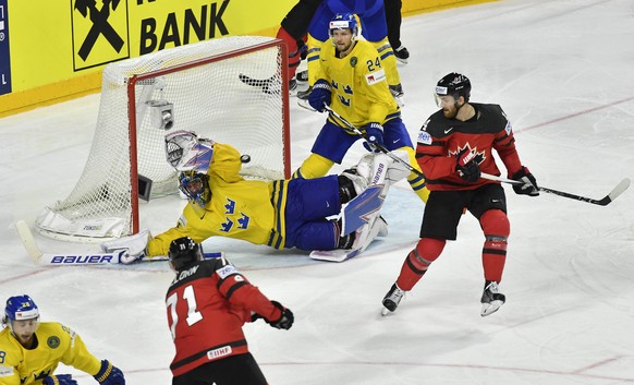 Sweden&#039;s Henrik Lundqvist makes a save in the overtime of the Ice Hockey World Championships final match between Canada and Sweden in the LANXESS arena in Cologne, Germany, Sunday, May 21, 2017.  ...