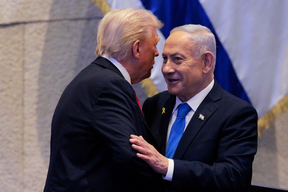 President Donald Trump talks with Israel&#039;s Prime Minister Benjamin Netanyahu at the Knesset, Israel&#039;s parliament, Monday, Oct. 13, 2025, in Jerusalem. (Chip Somodevilla/Pool via AP)
Trump Mi ...