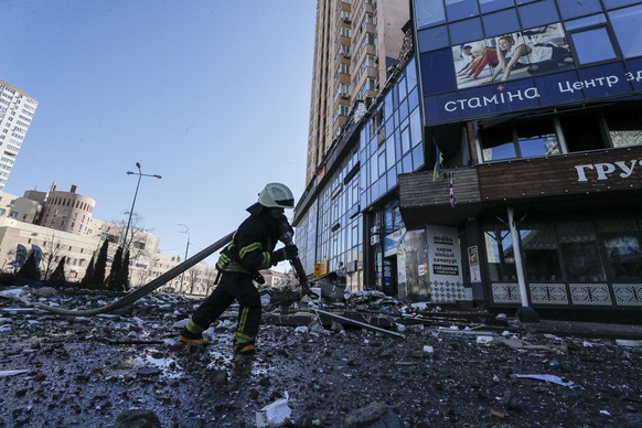 epaselect epa09785996 A Ukrainian firefighter fights a fire on a high-rise apartment block which was hit by shelling in Kiev, Ukraine, 26 February 2022. Russian President Vladimir Putin announced a &# ...