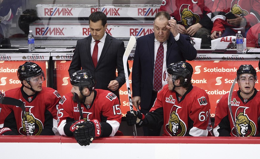Ottawa Senators head coach Guy Boucher, left, and assistant coach Martin Raymond react to a penalty during the first period of the first round of NHL Stanley Cup playoff hockey action against the Bost ...