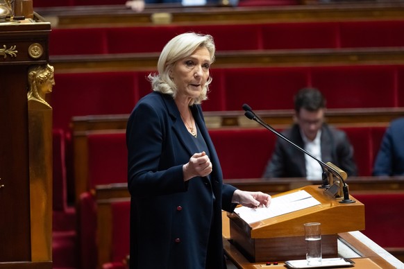 epa12673812 French member of Parliament for the far-right Rassemblement National (RN) party Marine Le Pen (C) delivers a speech during a session on two motions of censure against the government presen ...