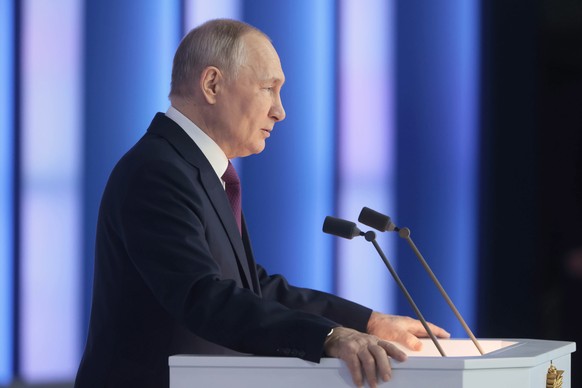 epa10481375 Russian President Vladimir Putin delivers his annual address to the Federal Assembly at the Gostiny Dvor conference centre in Moscow, Russia, 21 February 2023. About 1,200 people including ...