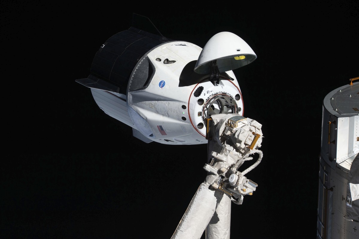 In this March 4, 2019 photo made available by NASA, the uncrewed SpaceX Crew Dragon spacecraft, with its nose cone open to expose the docking mechanism, approaches the International Space Station' ...
