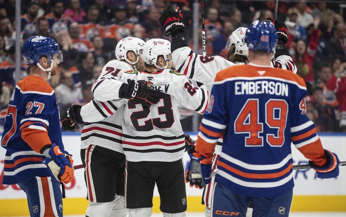 Chicago Blackhawks' Taylor Hall (71), Philipp Kurashev (23) and Tyler Bertuzzi (59) celebrate a goal against the Edmonton Oilers during the first period of an NHL hockey game, Saturday, Oct. 12,  ...