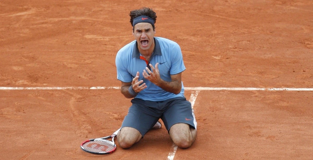 Switzerland's Roger Federer jubilates after defeating Sweden's Robin Soderling during their men's singles final match of the French Open tennis tournament at the Roland Garros stadium i ...