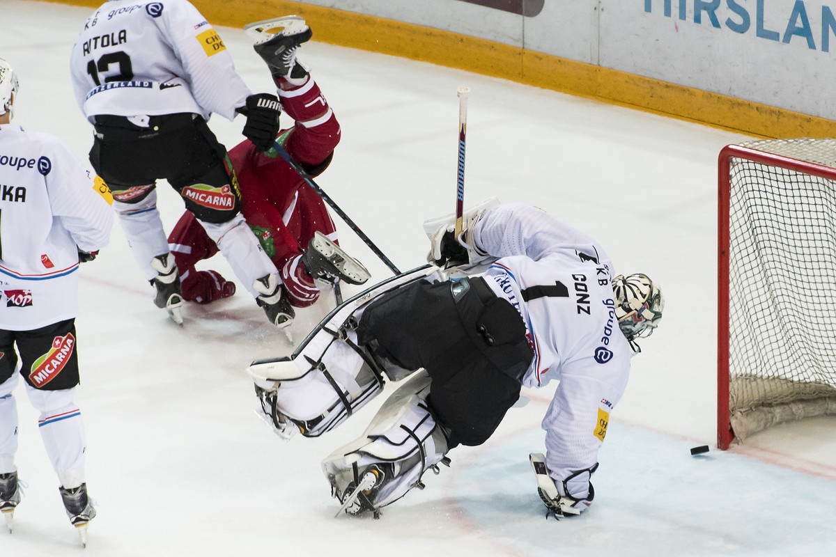 L'attaquant lausannois Gaetan Augsburger, gauche, marque le 2eme but face au le gardien Fribourgeois Benjamin Conz, droite, lors du match du championnat suisse de hockey sur glace de National Lea ...