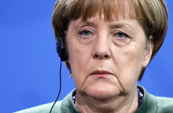 epa05761516 German Chancellor Angela Merkel listens to a translation during her joint press statement with Ukrainian President Petro Poroshenko (unseen) in the chancellery, in Berlin, Germany, 30 Janu ...