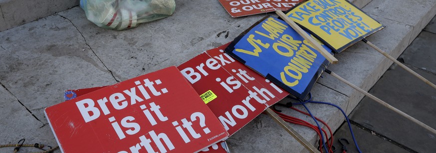 Brexit banners lie on the ground near parliament in London, Thursday, Jan. 17, 2019. British Prime Minister Theresa May is reaching out to opposition parties and other lawmakers Thursday in a battle t ...