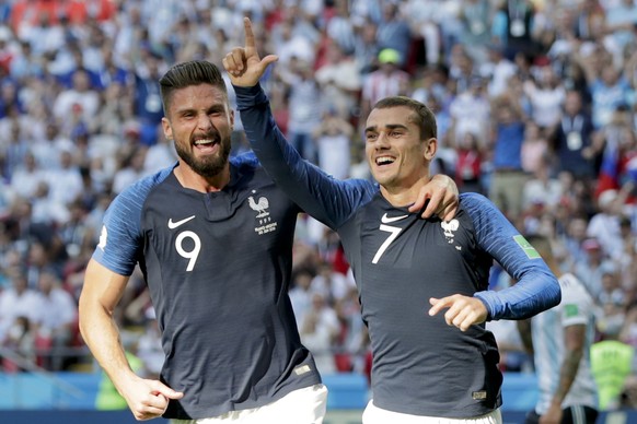 France&#039;s Antoine Griezmann, right, celebrates after scoring the penalty opening goal with France&#039;s Olivier Giroud, left, during the round of 16 match between France and Argentina, at the 201 ...