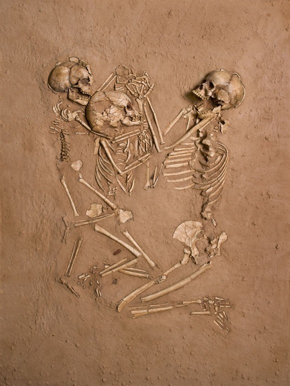 This undated handout photo provided by the National Geographic Society, shows the skeletons and artifacts of the exceptional triple burial at Gobero preserved in this cast exactly as found by Paul Ser ...