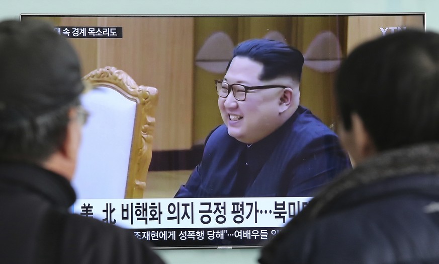 People watch a TV screen showing North Korean leader Kim Jong Un at the Seoul Railway Station in Seoul, South Korea, Wednesday, March 7, 2018. After years of refusal, North Korean leader Kim Jong Un i ...